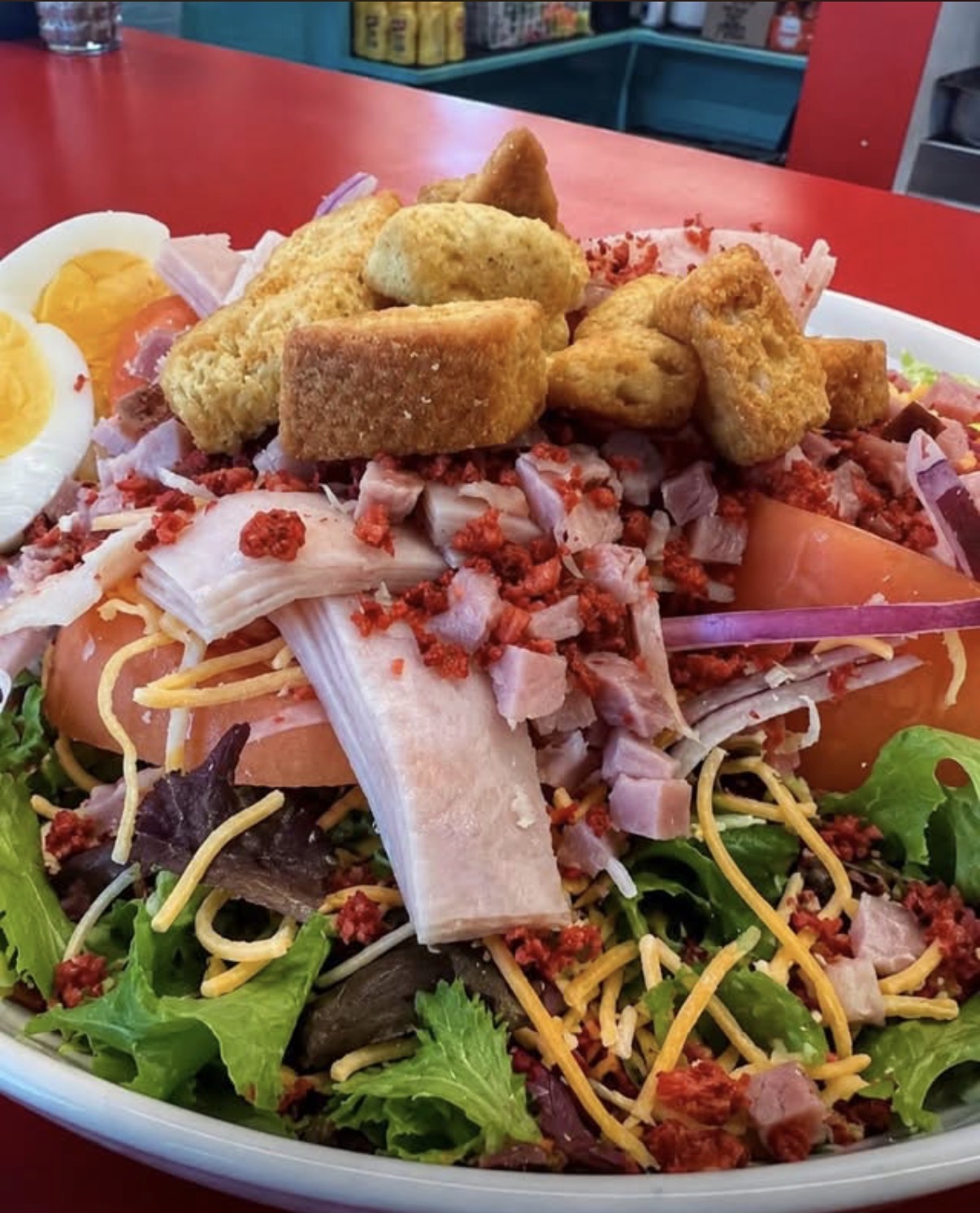 Chef salad with ham, turkey, egg, tomato, and cheese
